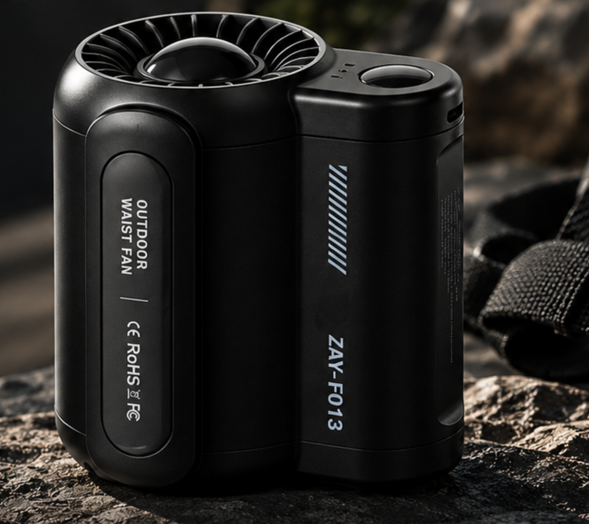 VORAIR Flow wearable cooling fan in black, resting on dark stone